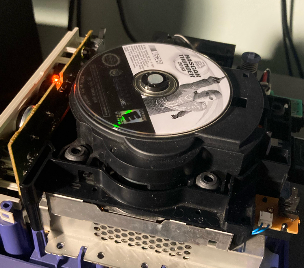 Close-up of a CD player mechanism with a CD inside