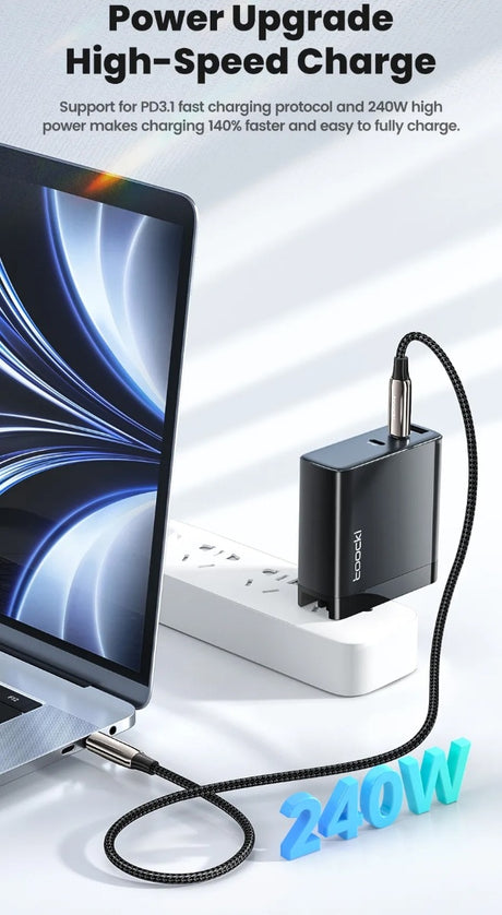 Image of a 240watt USB C Cable plugged into a wall adapter next to a computer