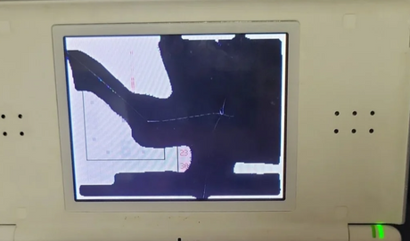 A Nintendo DS Lite with a black screen displaying a game image.