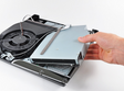Playstation 3 CD drive replacement being installed by a person with a screwdriver.