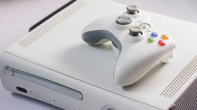 Laser assembly unit for Xbox 360, predominantly black in color with some green wiring and metallic parts visible.